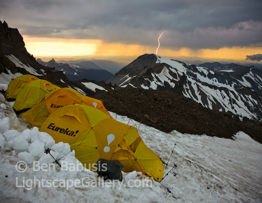 Rainier Thunderstorm. Mt. Rainier, Washington. A powerful evening thunderstorm struck at camp #1 on the Emmons Glacier route up Mt. Rainier. During a brief break in the storm, I slipped out quickly to photograph the sunset and was surprised by a lightning bolt which struck nearby Mt. Fremont just as I clicked the shutter in this hand held shot.  Ben Babusis, Lightscape Gallery.