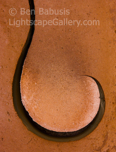 Hooked on Mud. Grand Canyon, Arizona. A hook shaped fissure developed along the drying muddy floor of a Grand Canyon tributary after a thunderstorm.  Ben Babusis, Lightscape Gallery.