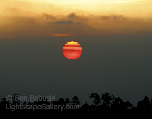 Fireball. Everglades National Park, Florida. The sun sinks behind a layer of coastal clouds in the Everglades.   Ben Babusis, Lightscape Gallery.
