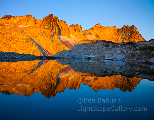 Tranquil Lake. The Enchantments, Washington. The warm light of early morning strikes the jagged peaks surrounding the aptly named Tranquil Lake in the Enchantments.  Ben Babusis, Lightscape Gallery.