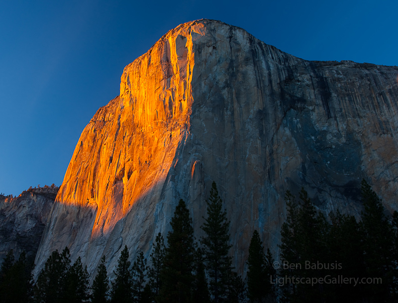 Monolith. Yosemite, CA. Southwestern flank of El Capitan is bathed in the warm light of the setting sun.  El Capitan is a granite monolith rising 3000 feet over the floor of Yosemite Valley.  Ben Babusis, Lightscape Gallery.