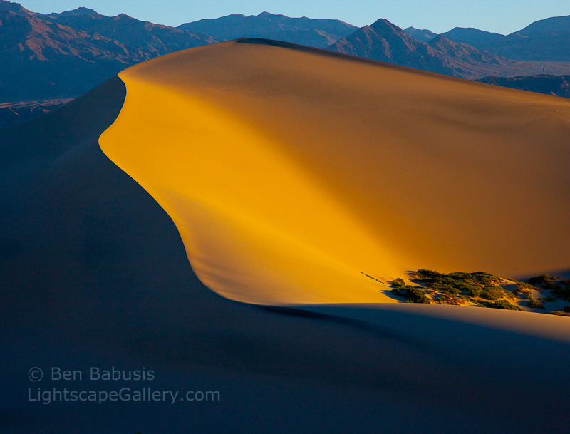 Orange Illumination. Death Valley, CA. The first rays of morning light bathe sand dunes in an orange glow at Stovepipe Wells in Death Valley.  Ben Babusis, Lightscape Gallery.