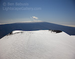 Two Volcanoes. Mauna Kea, Hawaii. A tiny plume of steam rises from the summit of Mauna Loa, the largest mountain the world by volume.  Image captured from the summit of nearby Mauna Kea, Hawaii's tallest peak and the tallest mountain in the world as measured from the seafloor.  Ben Babusis, Lightscape Gallery.