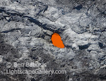 Fire Eye. Kilauea, Hawaii. Looking straight down into a window in a lava tube carrying molten rock down to the ocean from Kilauea. (Thanks to Blue Hawaiian Helicopters for aerial support.)  Ben Babusis, Lightscape Gallery.