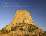 Devils Tower. Devils Tower, Wyoming. This beautiful tower in northwestern Wyoming is an igneous intrusion which was left standing after softer sedimentary rock surrounding it was eroded away. It was also the setting for the popular film 