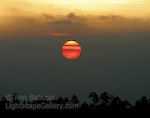 Fireball. Everglades National Park, Florida. The sun sinks behind a layer of coastal clouds in the Everglades.   Ben Babusis, Lightscape Gallery.