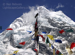 Prayers at Everest. Mt. Everest, Nepal. A bird perches atop a tent support decorated with prayer flags at the Everest basecamp. In the background lies Nuptse.  � Ben Babusis, Lightscape Gallery.