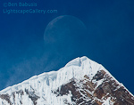Moonset over Annapurna. Annapurna Sanctuary, Nepal. The moon sets directly over a peak of the Annapurna Range from the flanks of Tharpu Chuli.  Ben Babusis, Lightscape Gallery.