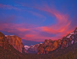 Fire in the Sky. Yosemite, CA. Clouds illuminated by alpineglow bathe Yosemite Valley in warm light well after sunset.  Colors in the sky became increasingly dramatic for nearly 45 minutes after sunset, until they were slowly extinguished by falling darkness. On the left is El Capitan, in the center Half Dome, and on the right Bridalveil Falls.  Ben Babusis, Lightscape Gallery.