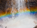 Colorspray. Yosemite, CA. Mist from Upper Yosemite Falls creates a beautiful rainbow as it crashes down on an ice cone at its base during this winter visit.  Ben Babusis, Lightscape Gallery.