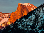 Half Light. Yosemite, CA. The warm setting sun illuminates Half Dome in Yosemite National Park. The dark foreground creates a split image of half color and half black and white.  Ben Babusis, Lightscape Gallery.