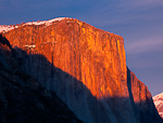 Red Cap. Yosemite, CA. The warm winter alpinglow enhanced by clouds in the sky reflects off of El Capitan just after sunset.  Ben Babusis, Lightscape Gallery.