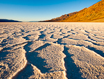 Salty Sunrise. Badwater Basin, Death Valley. Winter sunrise on Badwater Basin in Death Valley National Park (282 feet below sea level). Early morning light enhances the geometric shapes formed by water pooling on the salt formation.  Ben Babusis, Lightscape Gallery.