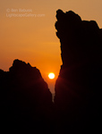 Crack of Sunset. Wailea, Maui. Sun sets behind a cracked lava rock off the coast of Maui.  Ben Babusis, Lightscape Gallery.
